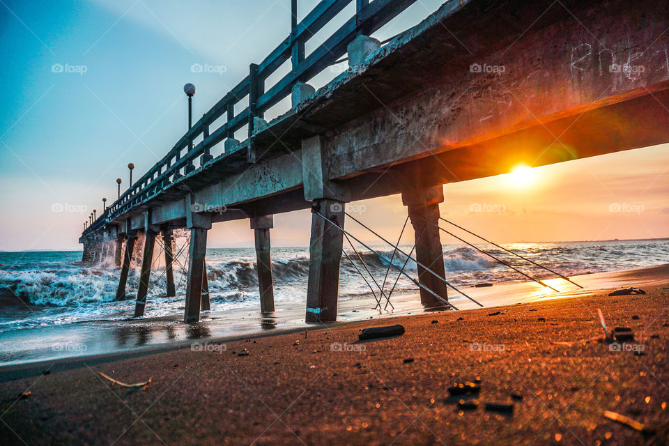 Spectacular sunset showing Mother Nature in front of a pier in the Pacific Ocean