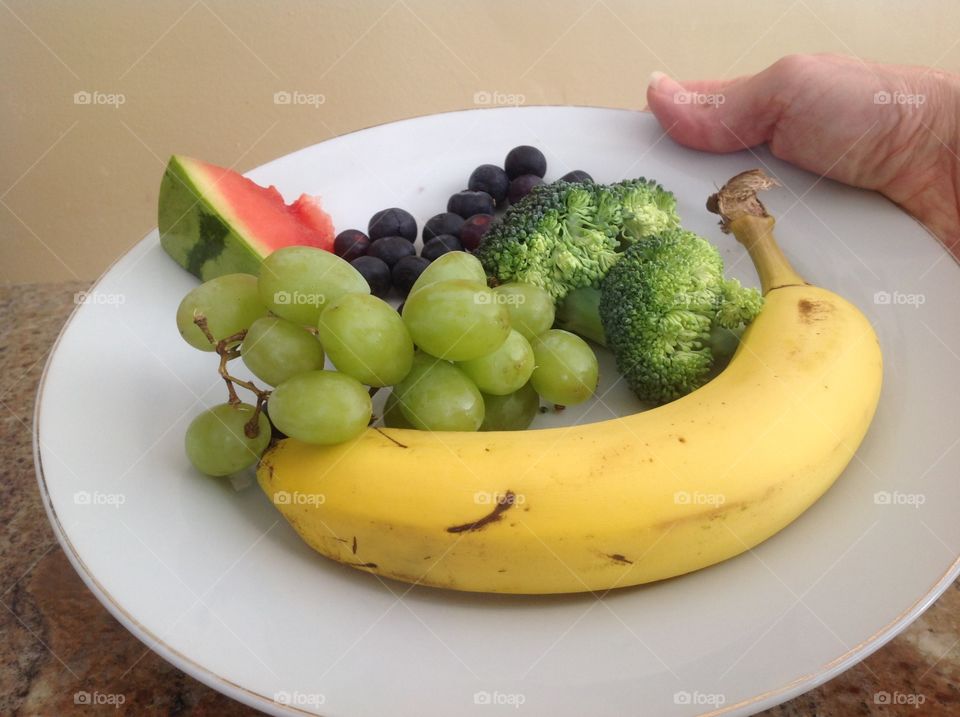 Colorful plate of fruits and vegetables that are good for you.