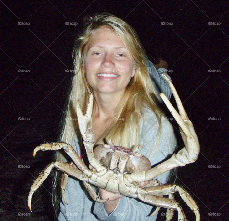Woman holding crab in hand