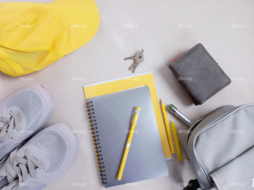 yellow cap, yellow notebook.