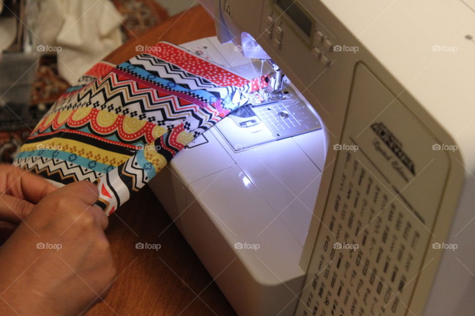 handy woman working on sewing machine 