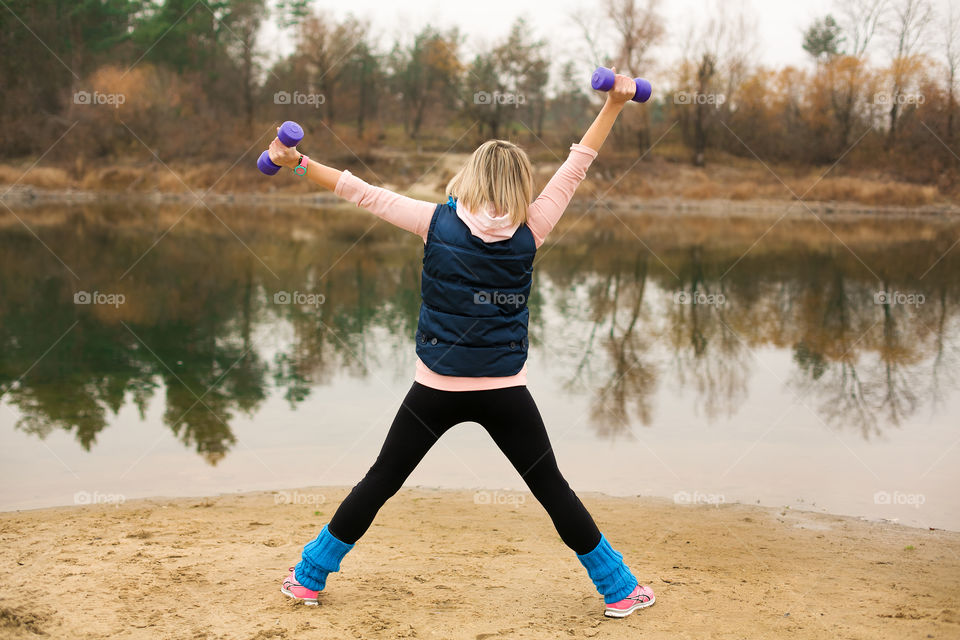 Girl exercising near the water