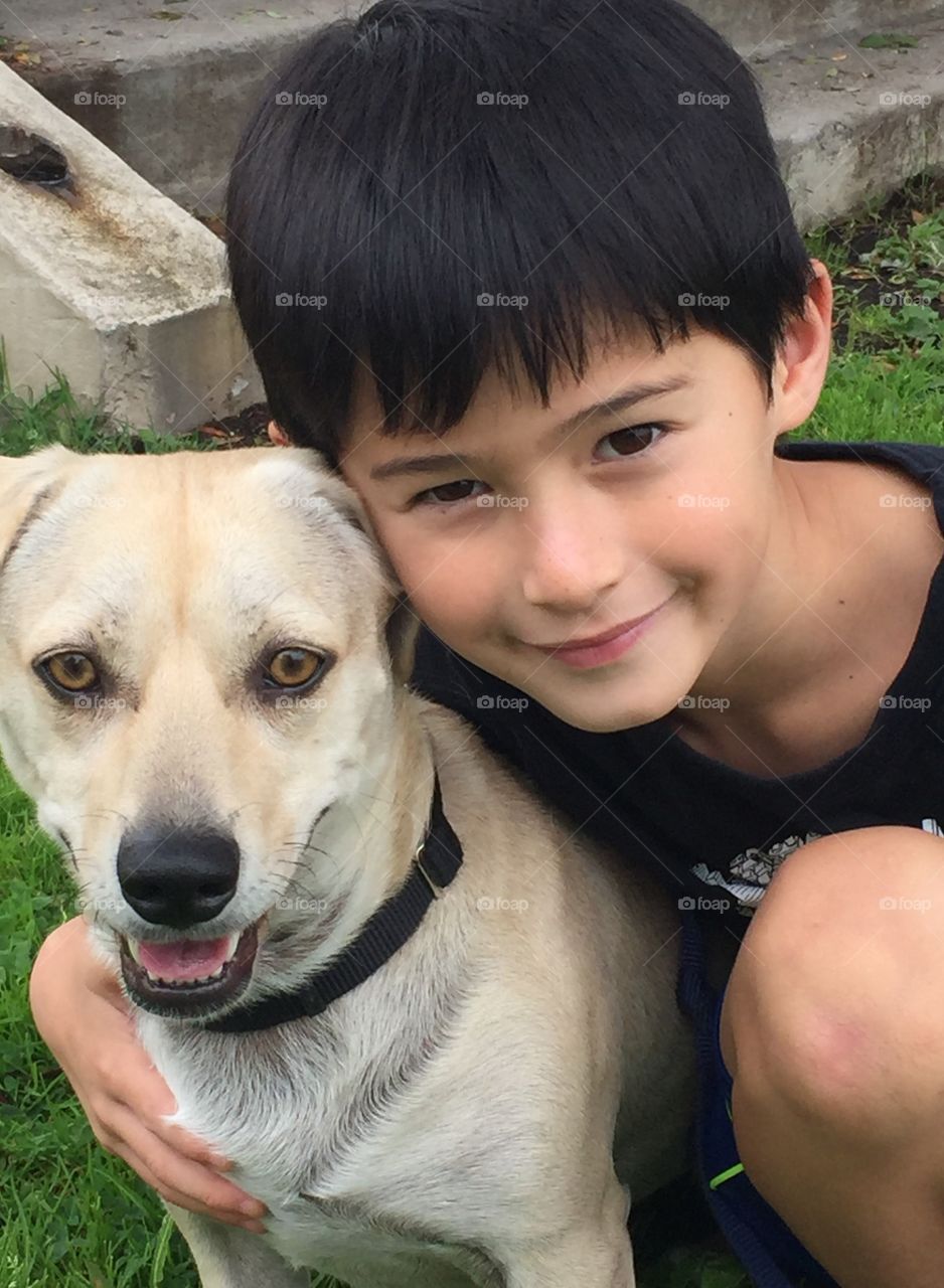 Close-up of handsome boy with dog