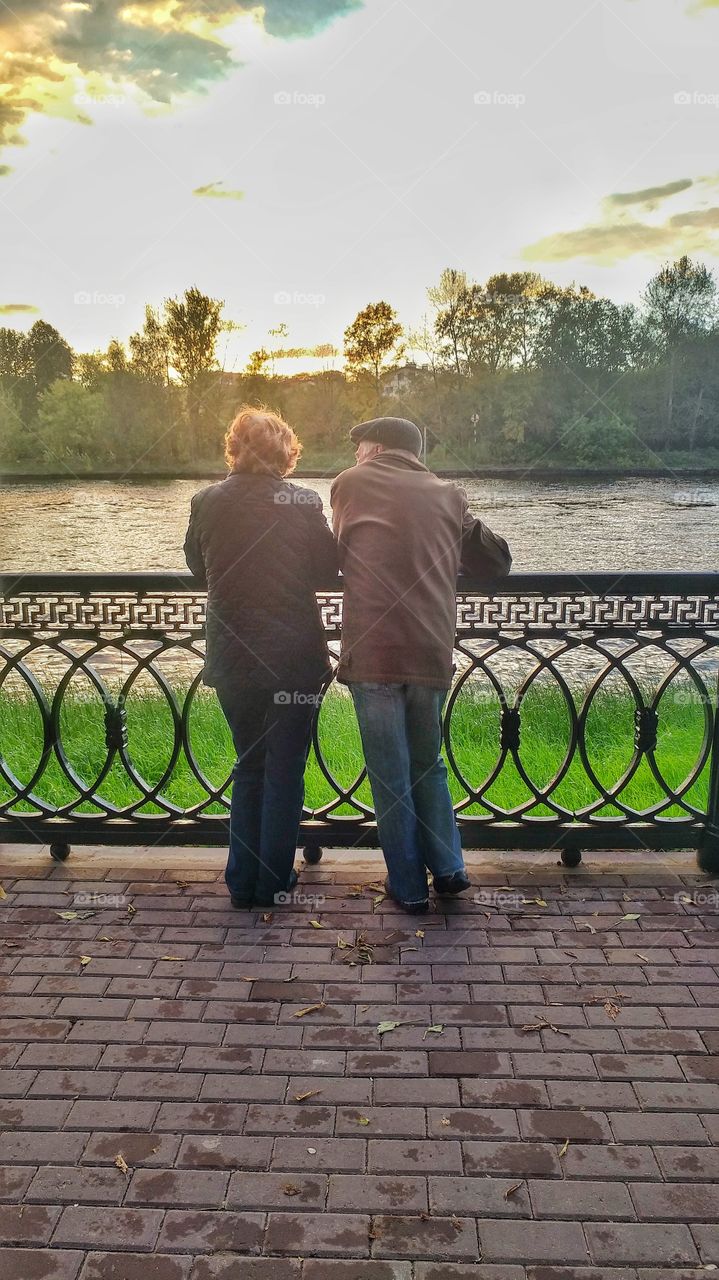 This couple went for a walk along the river. 
