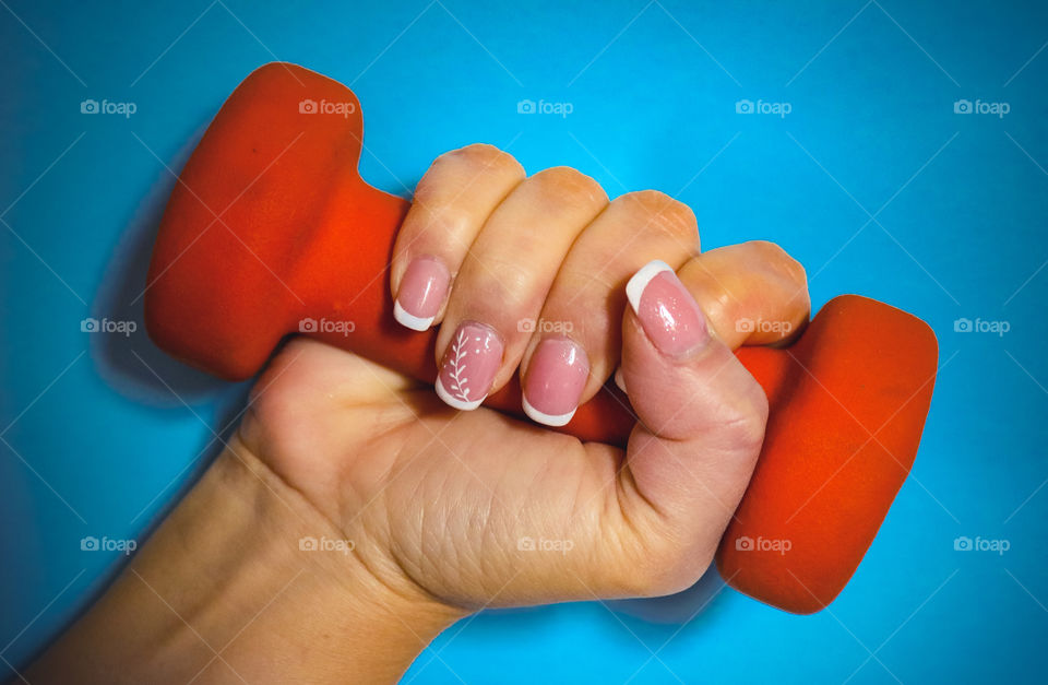 A hand holding fitness weight