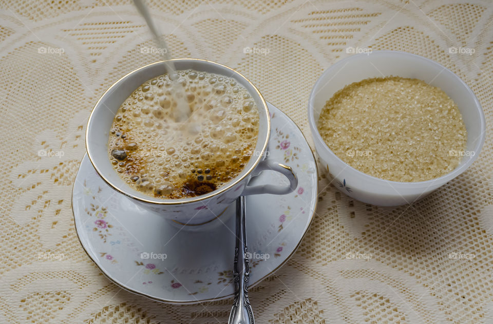 Pouring Milk In Coffee Cup