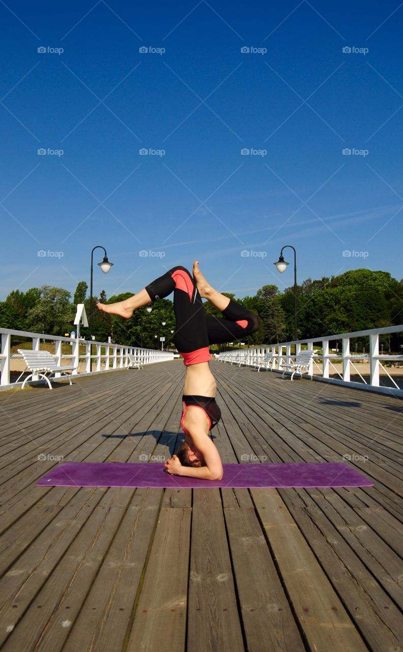Yoga on the pier at the polish seaside 