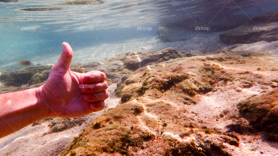 man giving thumb up underwater