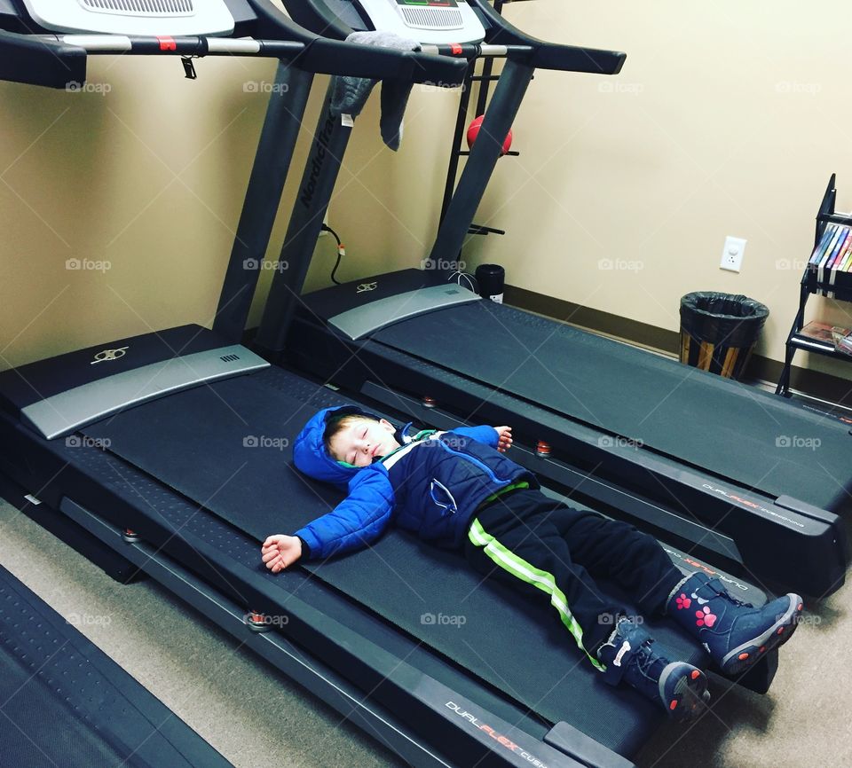 Baby boy sleeping on treadmill
