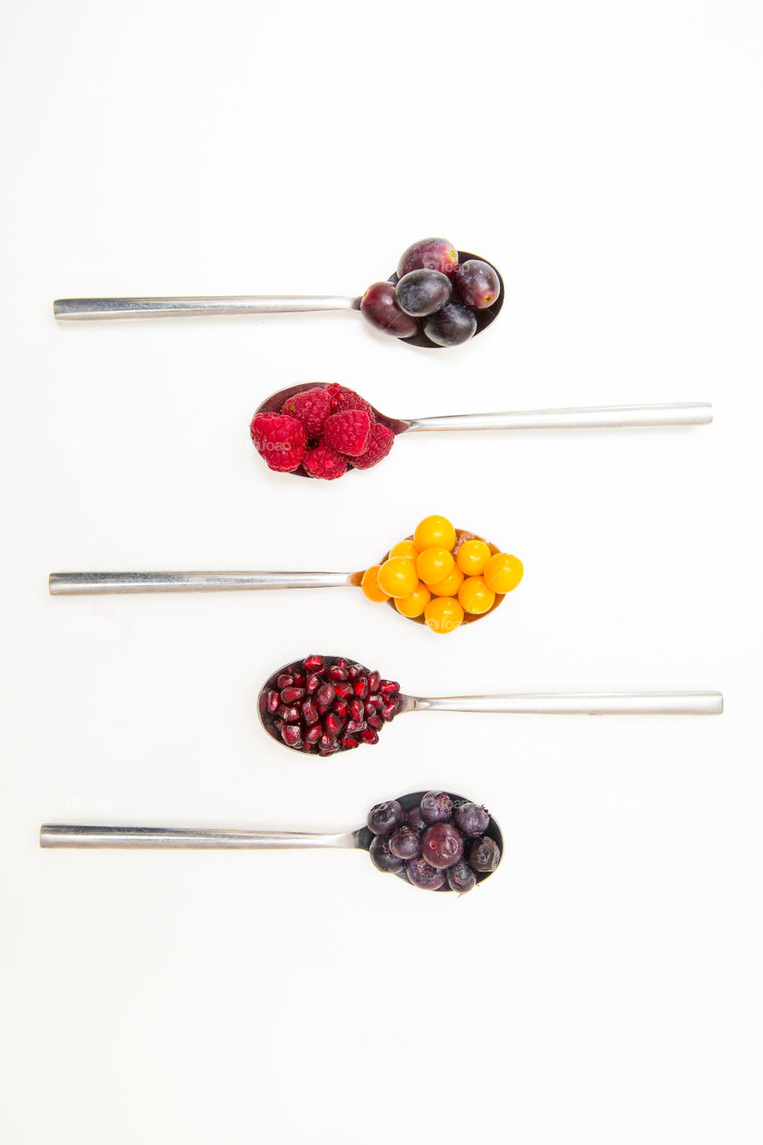 Flat lay of spoons with different fresh summer berries and fruits. I love fresh fruit as part of a healthy diet.