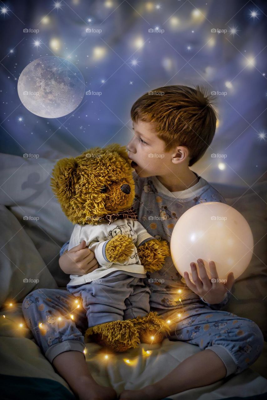 Boy with Teddy bear night at home