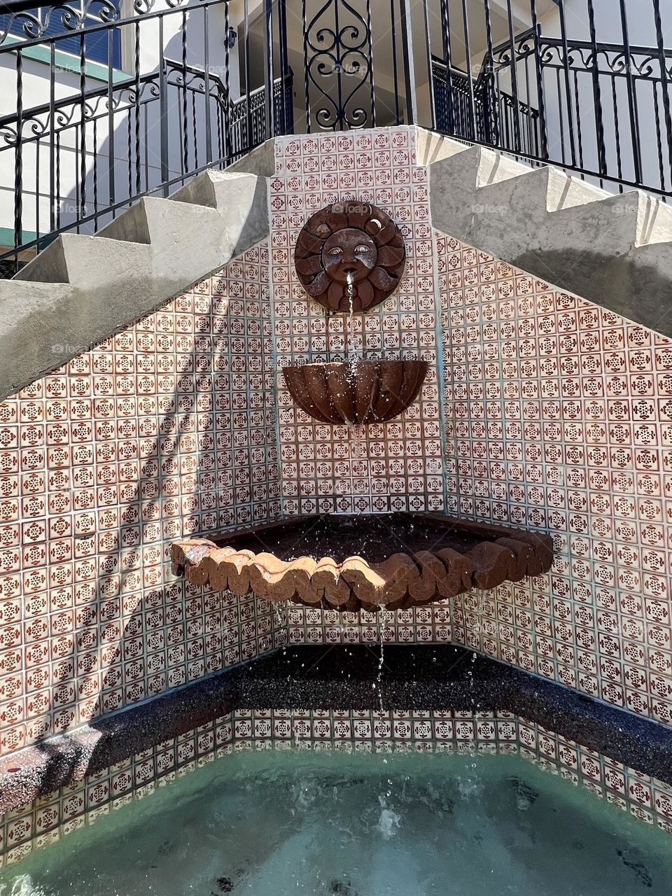 A cascading water fountain at the corner 