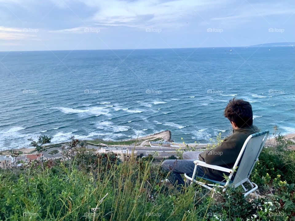 Man seat and viewing over the sea