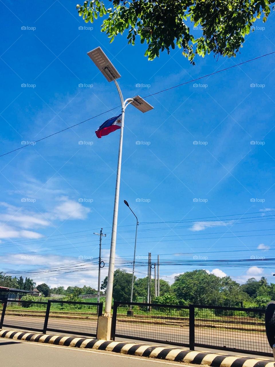 Philippine flag on the top of street lights at the public high ways 