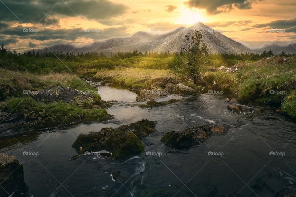 Amazing sunrise scenery with river stream and mountains in the background at Connemara National park in County Galway ,Ireland