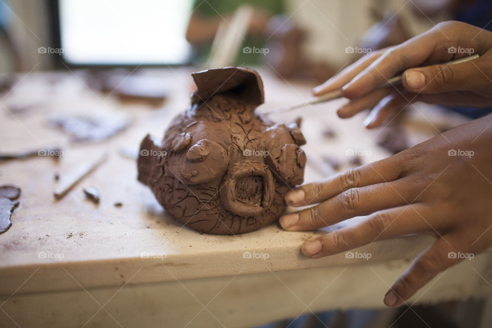 Something Fishy. A teenager works on a clay bank at summer camp. 
