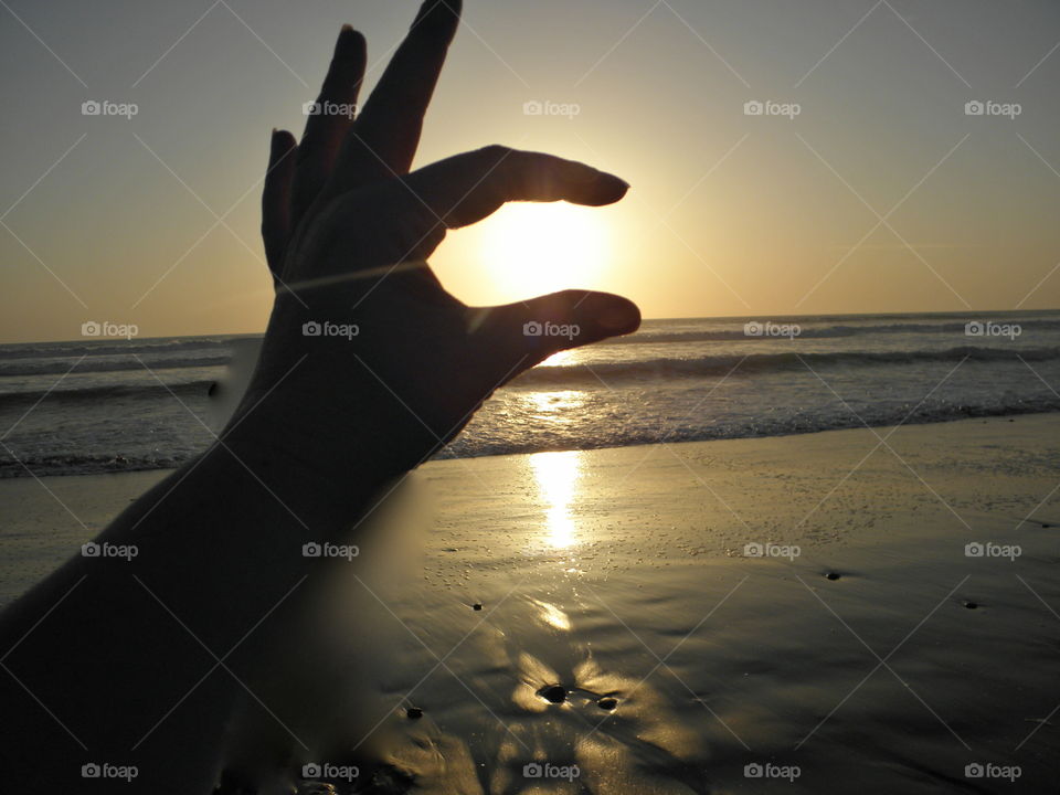 Sun in between fingertips