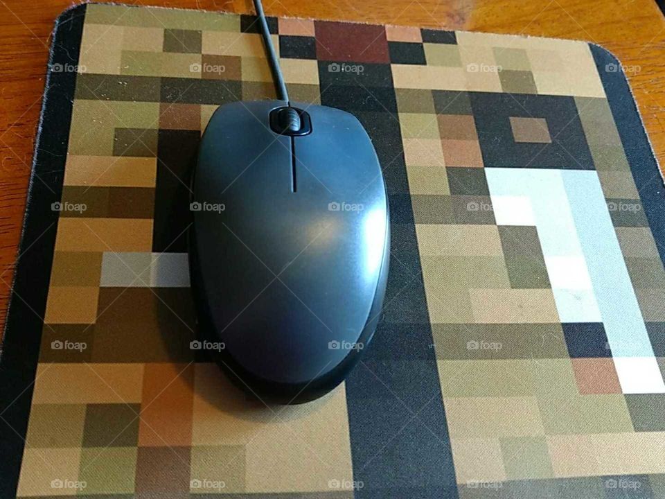 a mouse sitting on a video game themed mouse pad