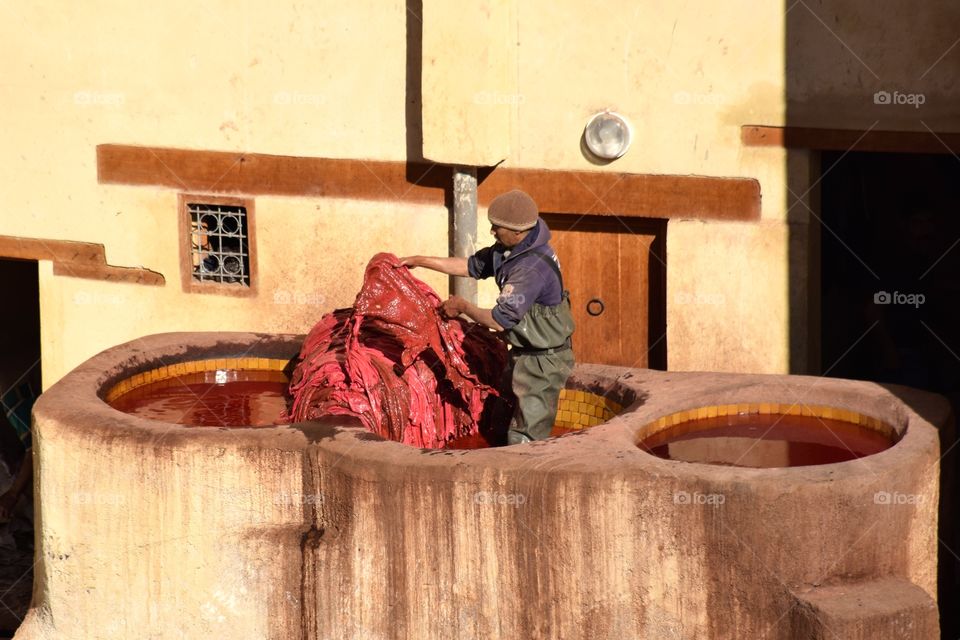 Man working with leather at Fez tannery, Morroco