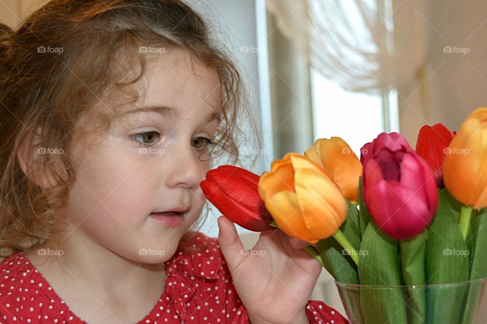 Close-up of girl touching face flower