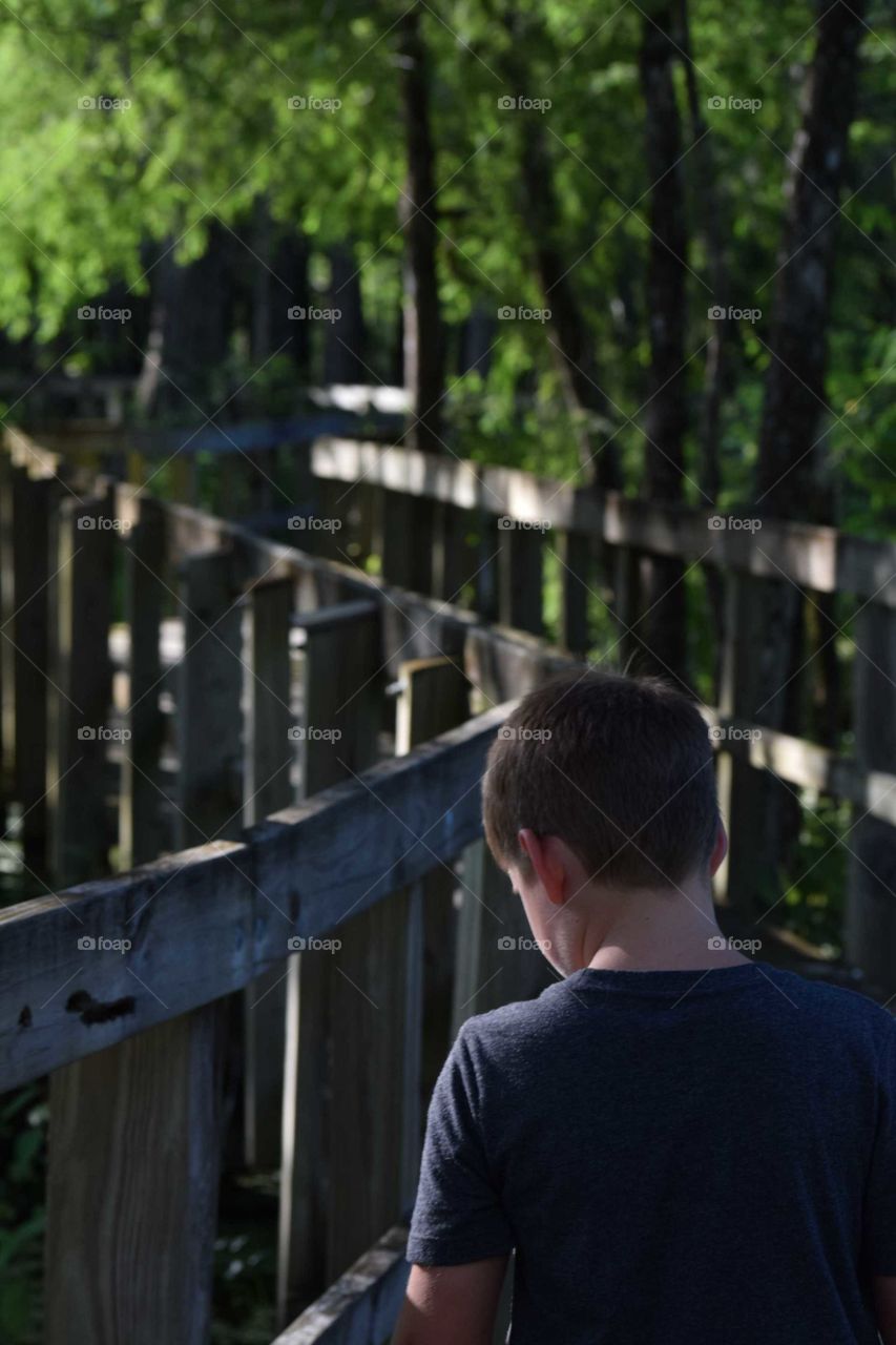 child on a wooden walkway