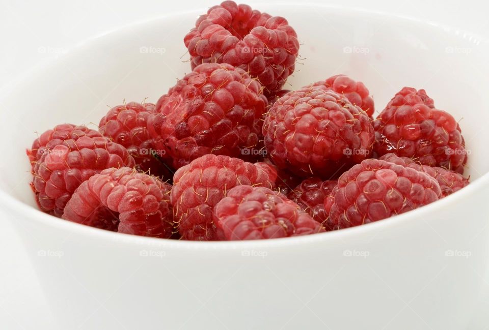 Raspberries in a white bowl