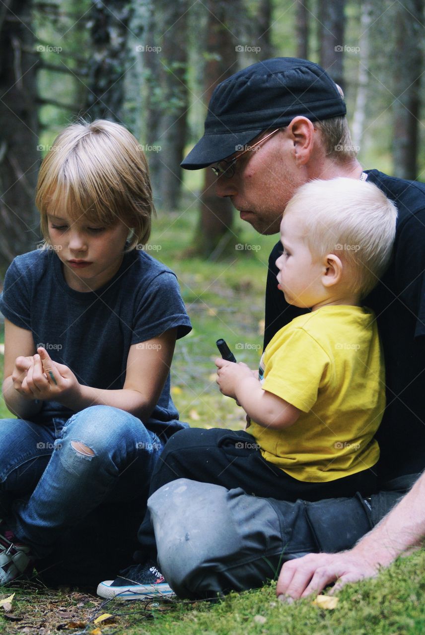 Children sitting on father lap