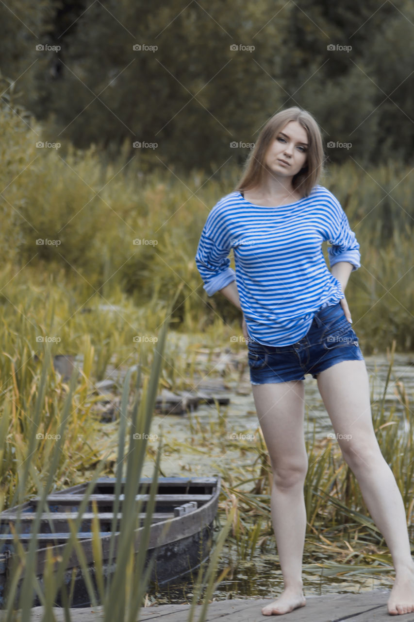 A girl with blond hair on the lake in a striped shirt and short denim shorts on the background of grass, reeds and an old wooden boat
Girl, woman, man, blonde, blonde hair, striped shirt, short shorts, denim shorts, shore, lake, grass, reeds, old boat, feelings, emotions, tenderness, love, lifestyle, lifestyle, vacation