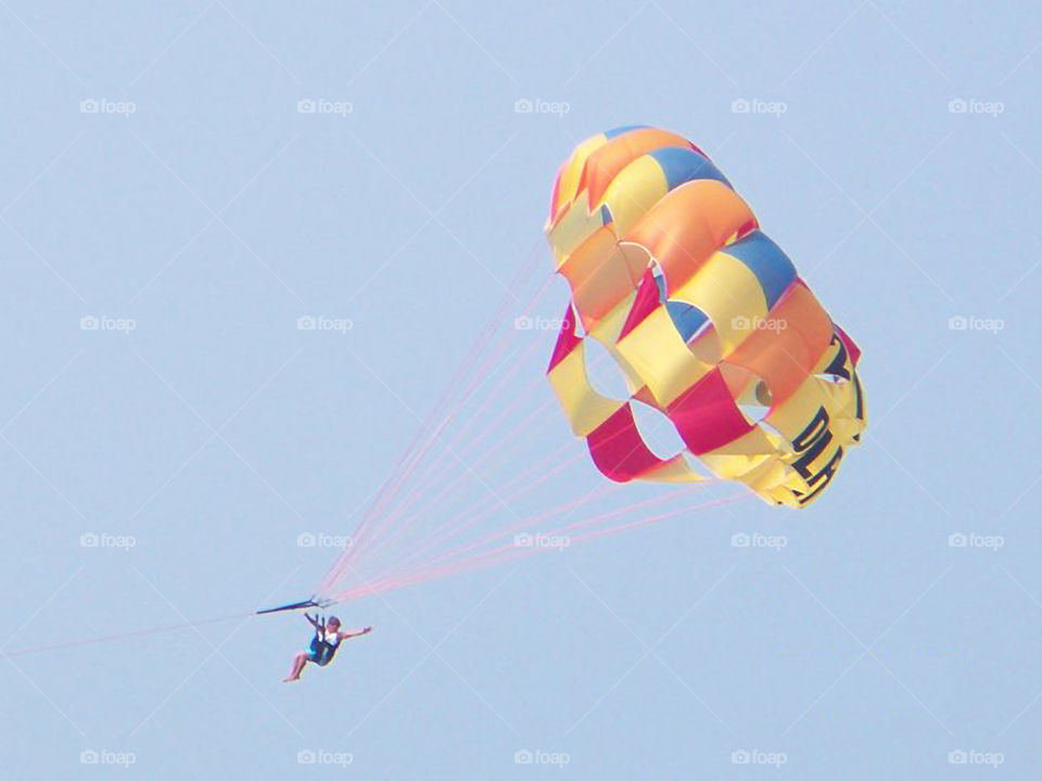 Parasailing in Orange Beach 2. A person parasailing in Orange Beach Alabama.