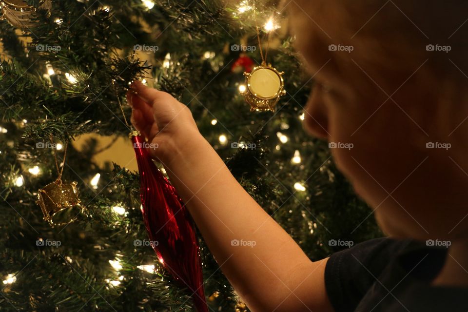 Hanging ornaments on Christmas tree