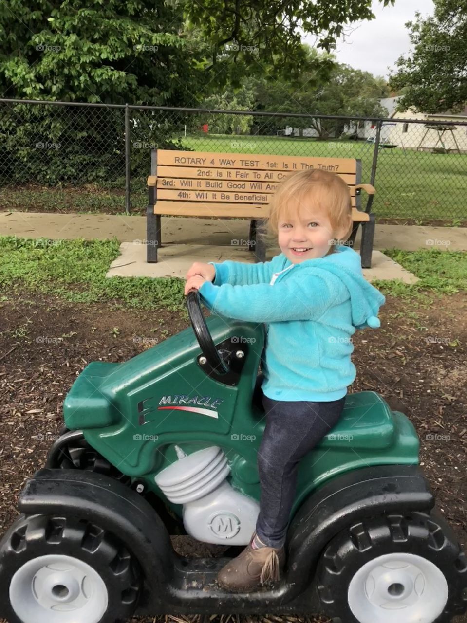 Little girl on Tractor Toy in the Park 
