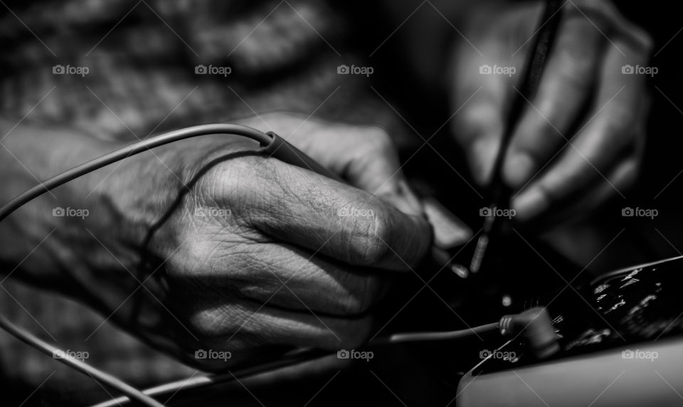 Technician using multi meter in workshop
