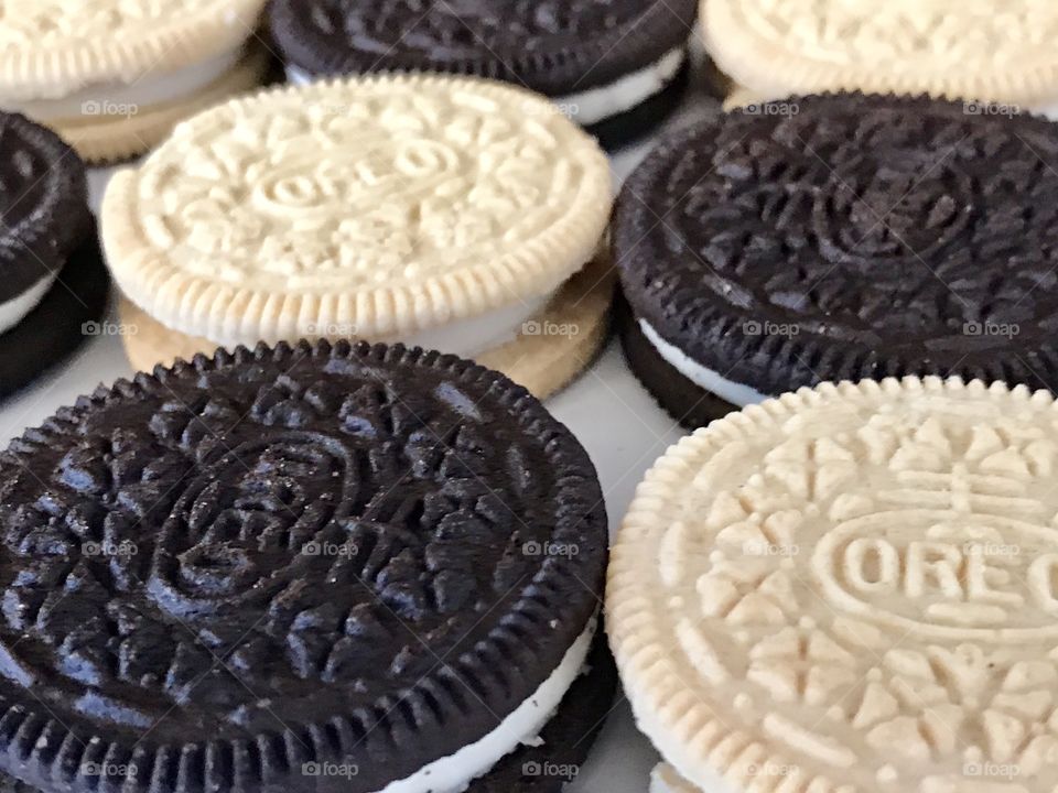 Golden and double stuffed chocolate Oreo cookies  Contrasting flat lay