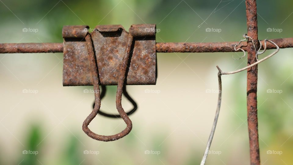 Old rusted metal binder clip.