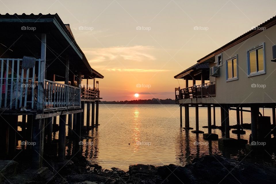 Scenic view of sea against sunset sky