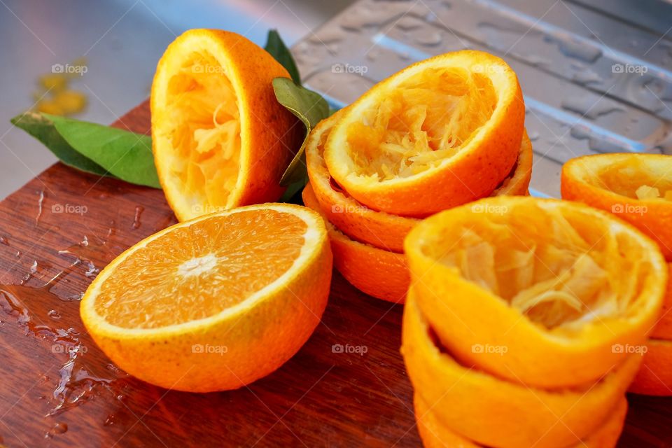 Split in a half oranges on a wooden board