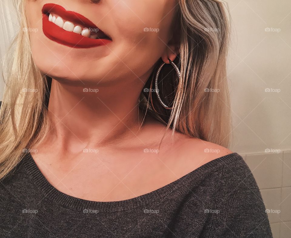Blonde girl wearing red lipstick and smiling