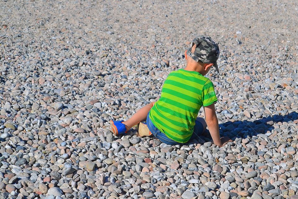 boy playing with stones