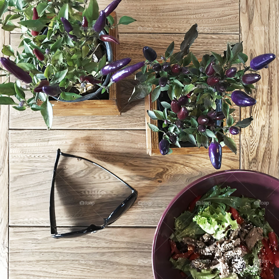 Plants and salad on wooden table