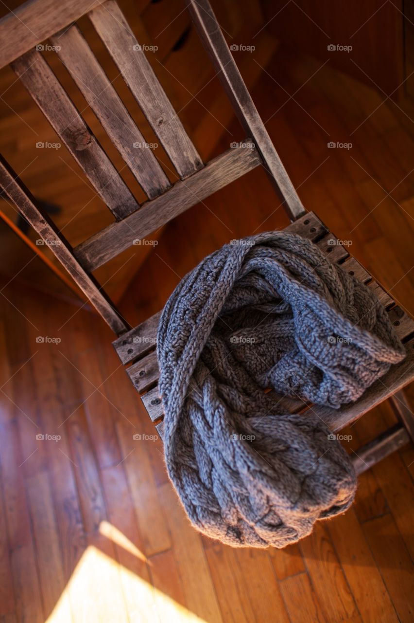 Warm scarf. warm scarf lying on a chair at home