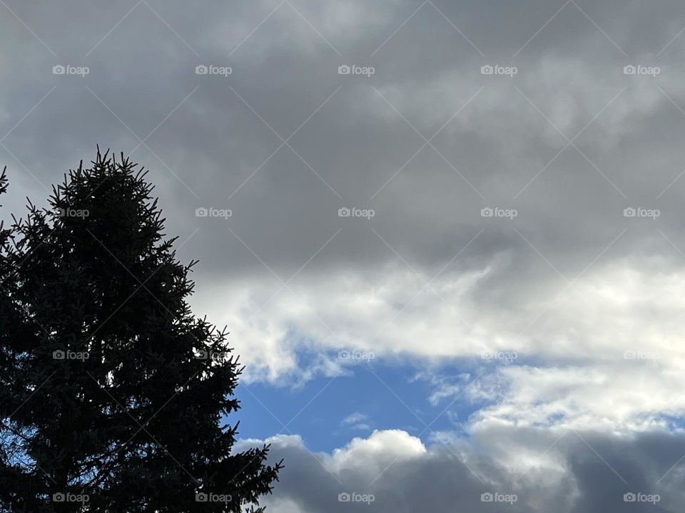 Cloudy with a patch of blue sky
