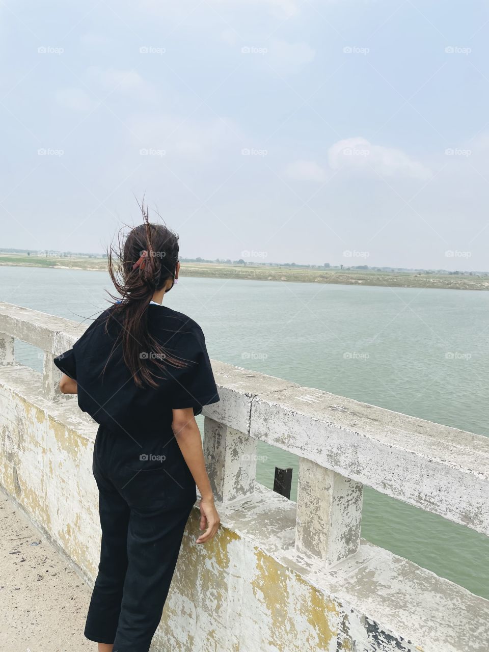 Enjoying cold air on the river bridge in summer