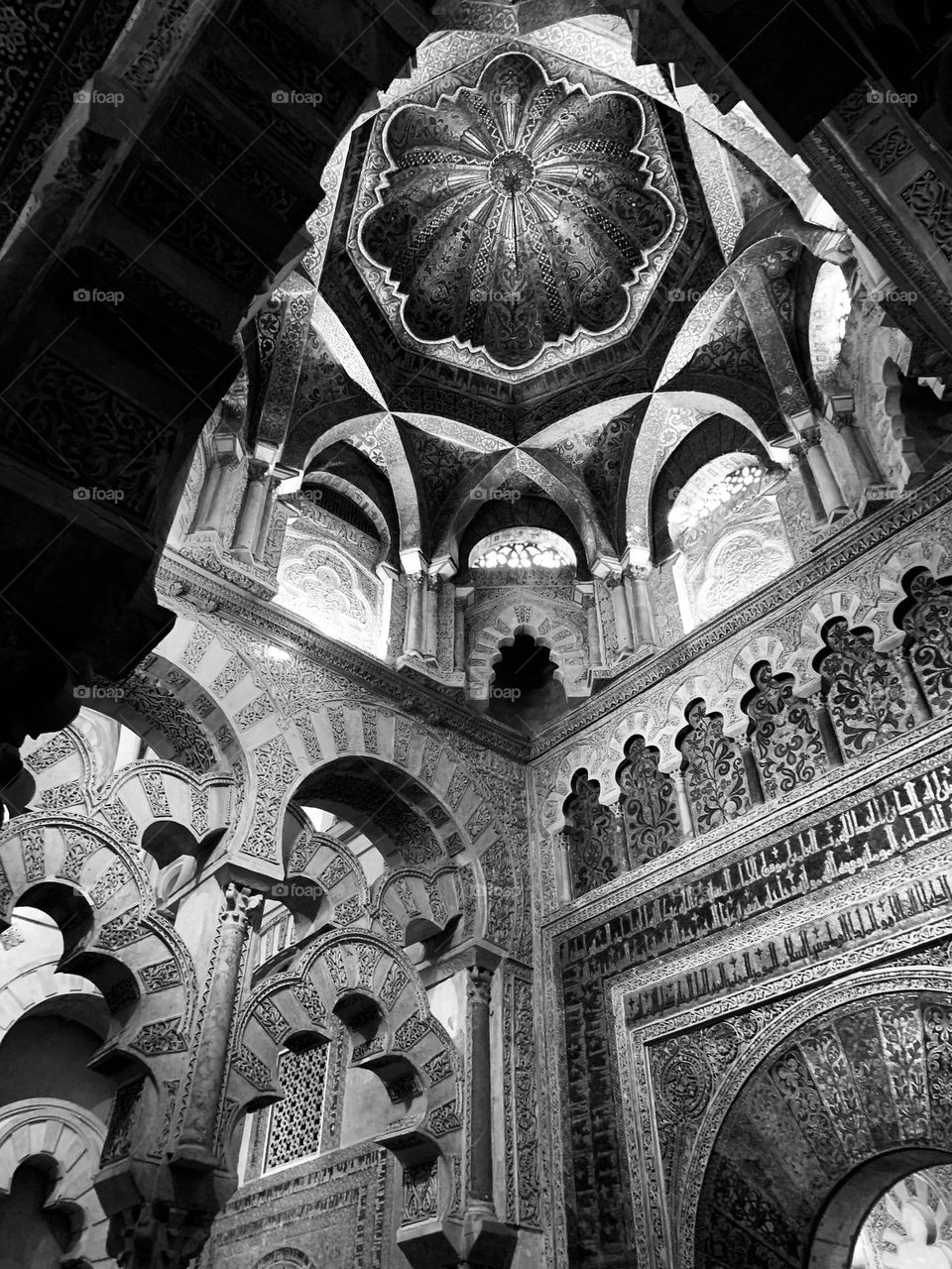 wonderful chiselled decorations and arabesques carved in marble inside the Mezquita, the mosque cathedral of Cordoba, Spain; architectural arches and domes 