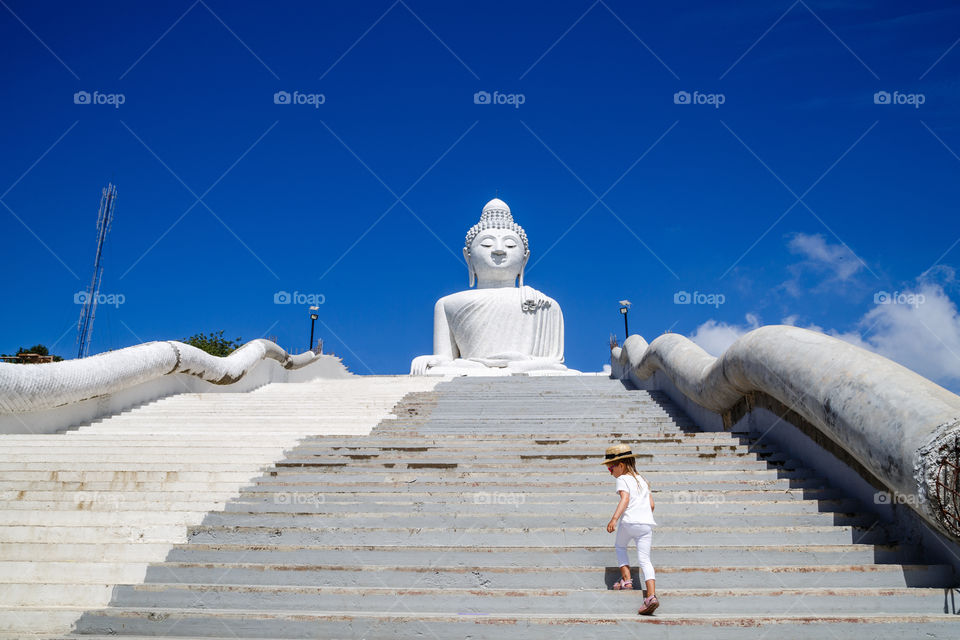 Little girl and Big Buddha, Phuket island, Thailand 