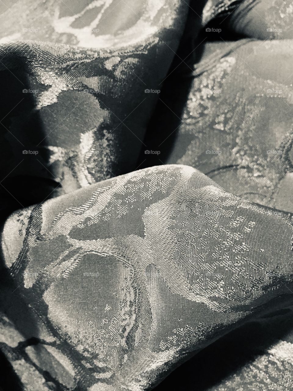 A silvertone  abstract from a closeup of some textured embossed fabric.  