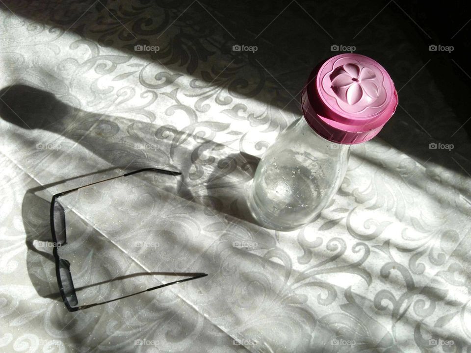 Magic bottle shadow and glasses.