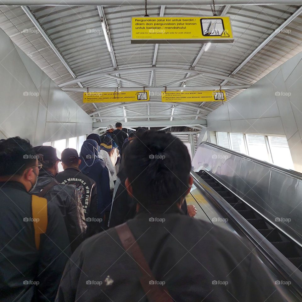 the activity of many people who are going up the escalator, but no one is going down