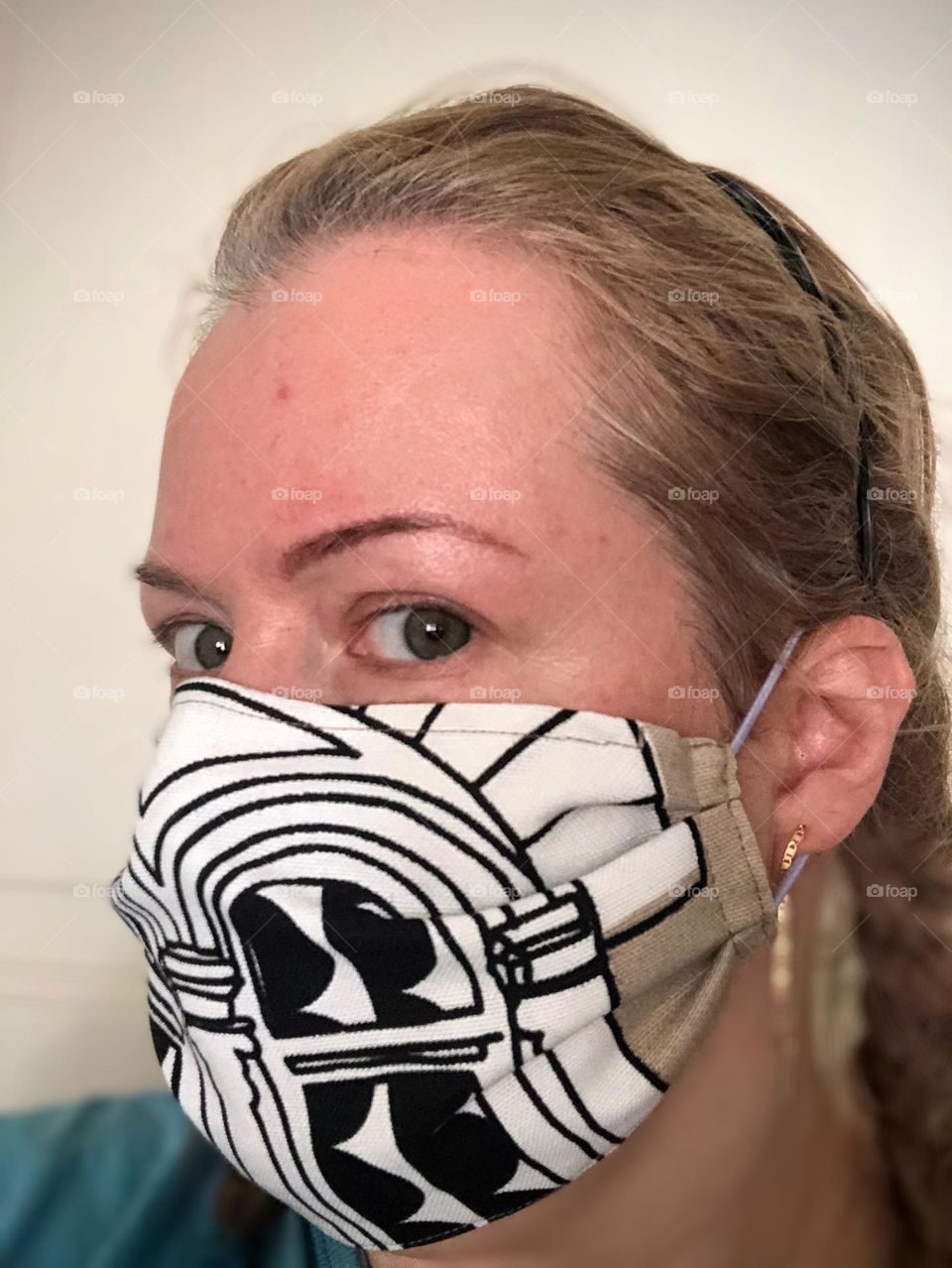 Close up of young women in handmade fabric mask looking intensive to the camera