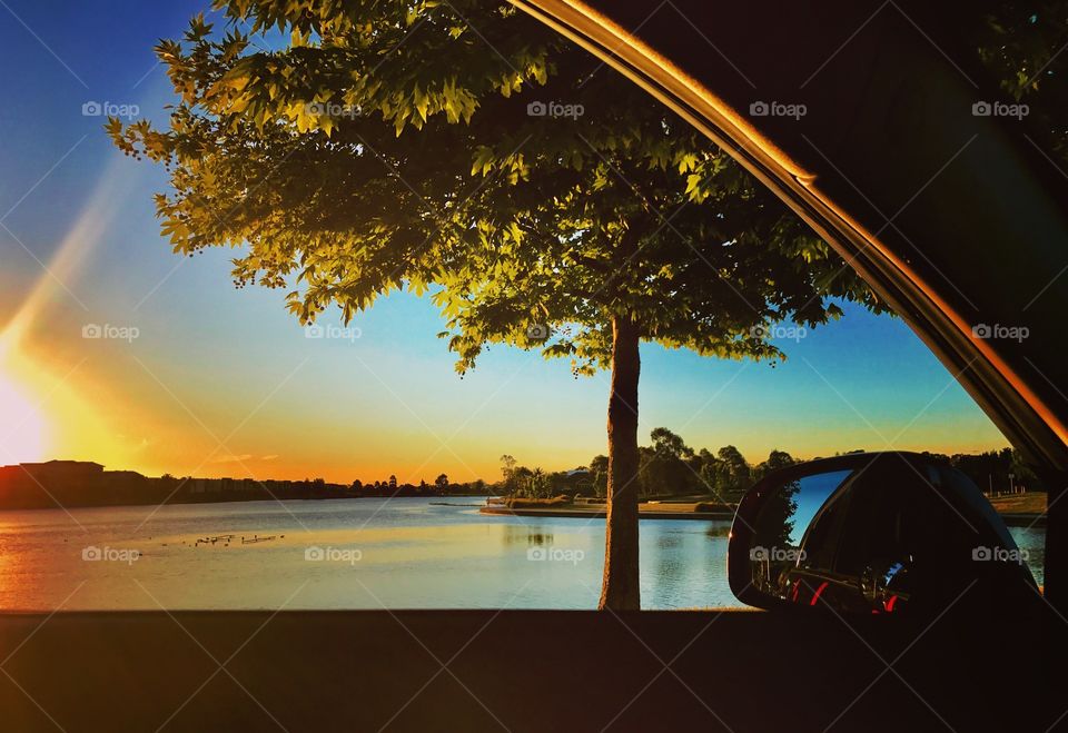 Looking out the car window at the stunning sunset over the lake. 