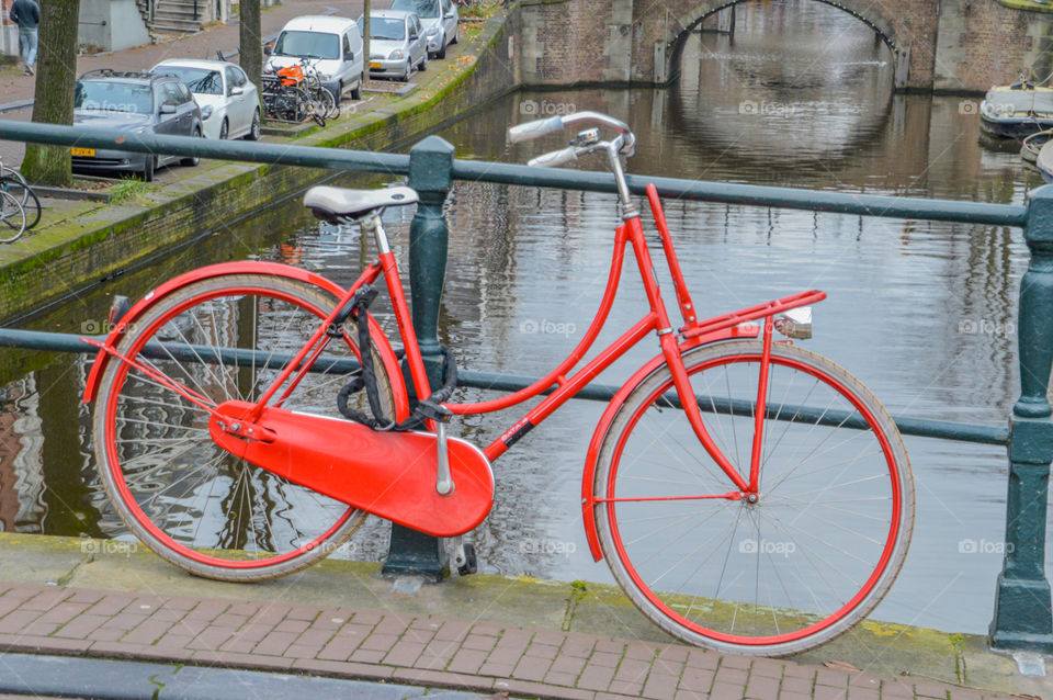 Red Bicycle On A Bridge At Amsterdam The Netherlands